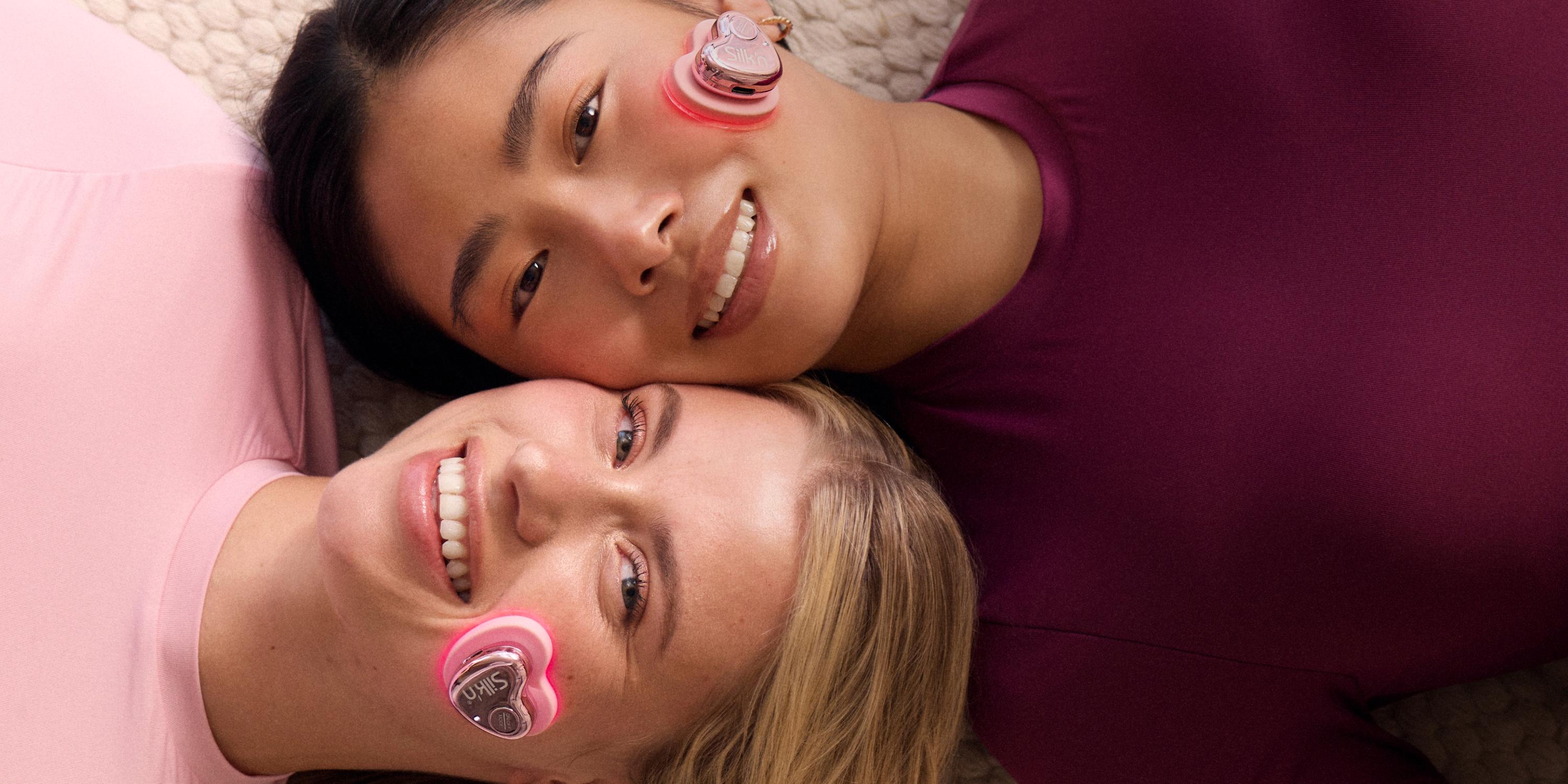 Smiling women using the new Silk'n beauty device: LumiGlow for targeting blemishes and fine lines