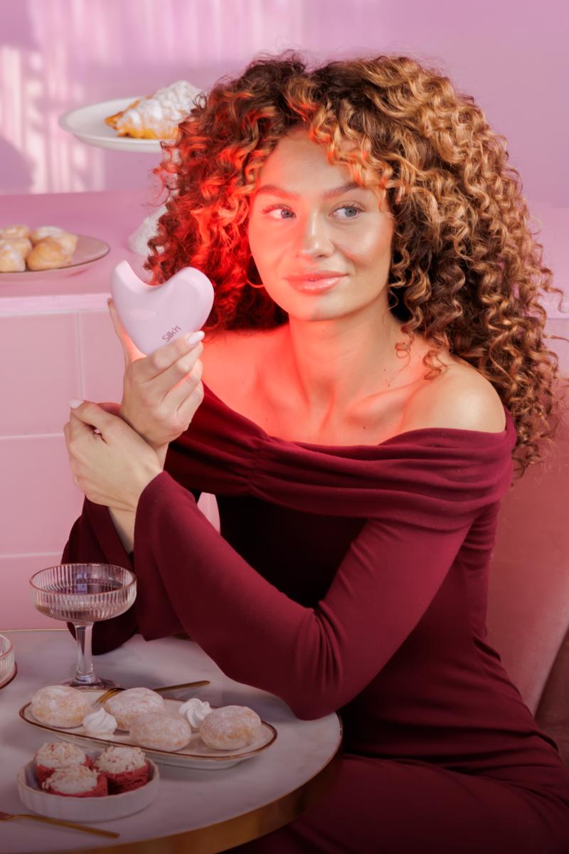 Woman holding the LumiLips Pink - LED Light therapy for your lips