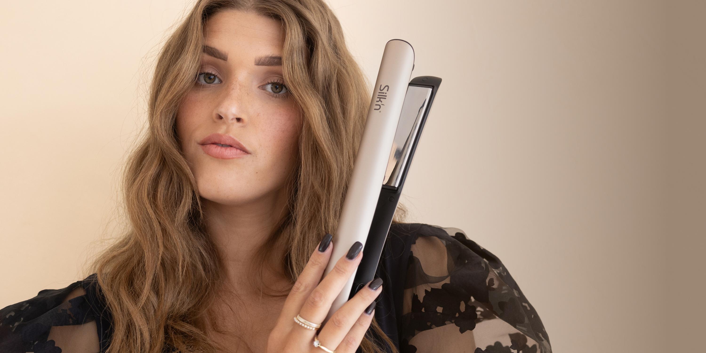 Woman using the SilkyStraight infrared hair straightener