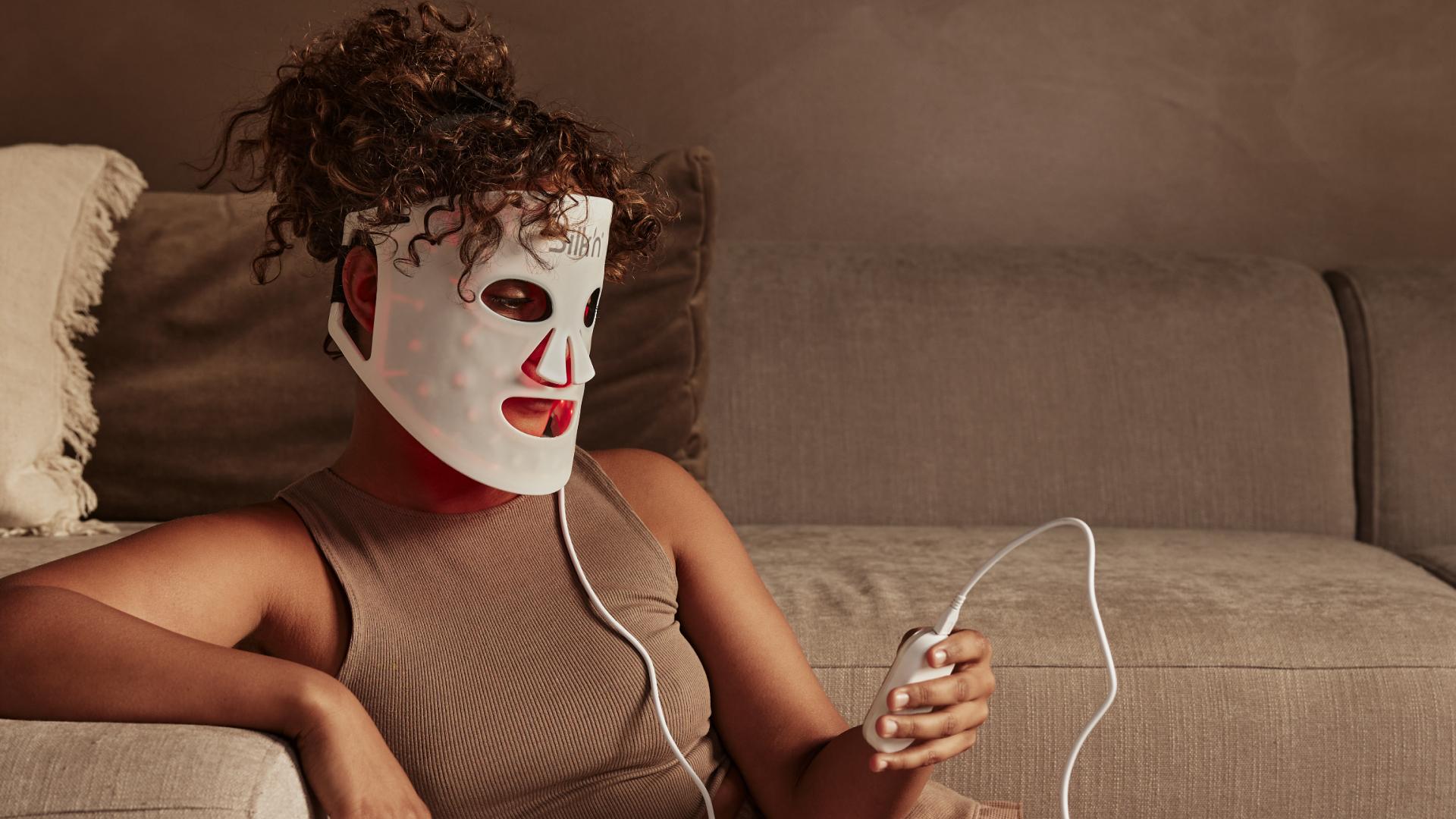 Woman using Red Light Therapy for anti-aging treatment with the Silk'n LED Face Mask