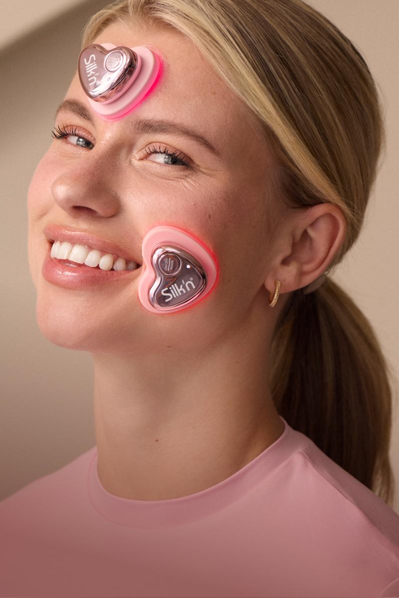 Smiling women using the new Silk'n beauty device: LumiGlow for targeting blemishes and fine lines