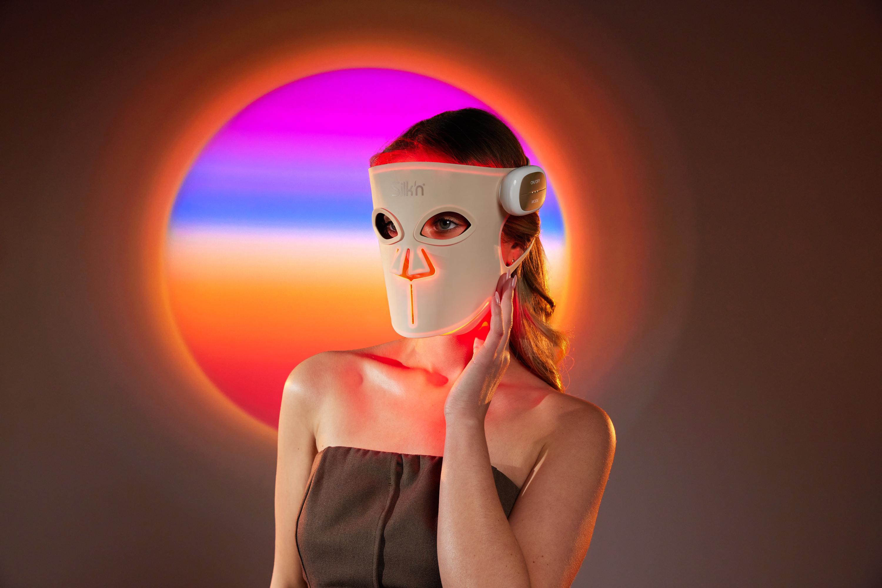 Woman wearing an LED Face Mask with Red Light Therapy, wondering how to use it and how it works