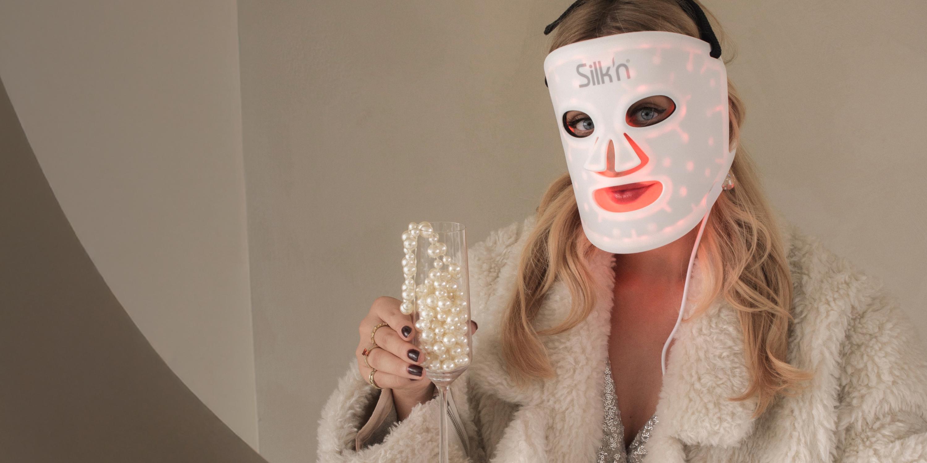 A beautifully dressed woman in a festive mood with the LED mask 100