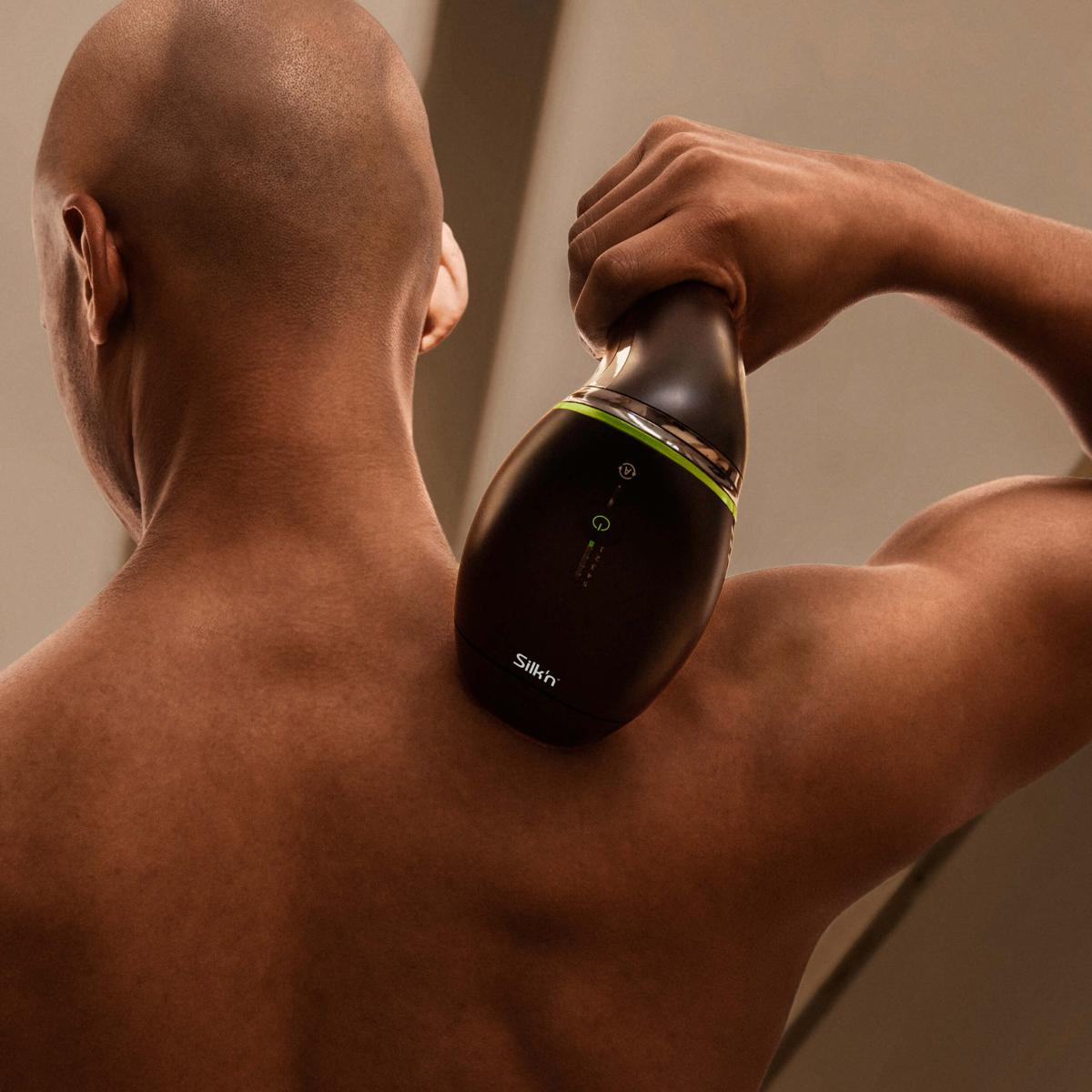 Man using the Silk'n 7 ipl hair removal device on back and shoulders