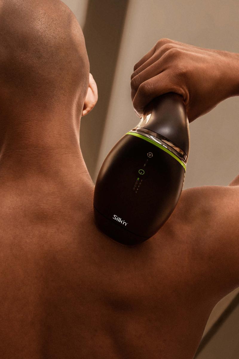 Man using the Silk'n 7 ipl hair removal device on back and shoulders