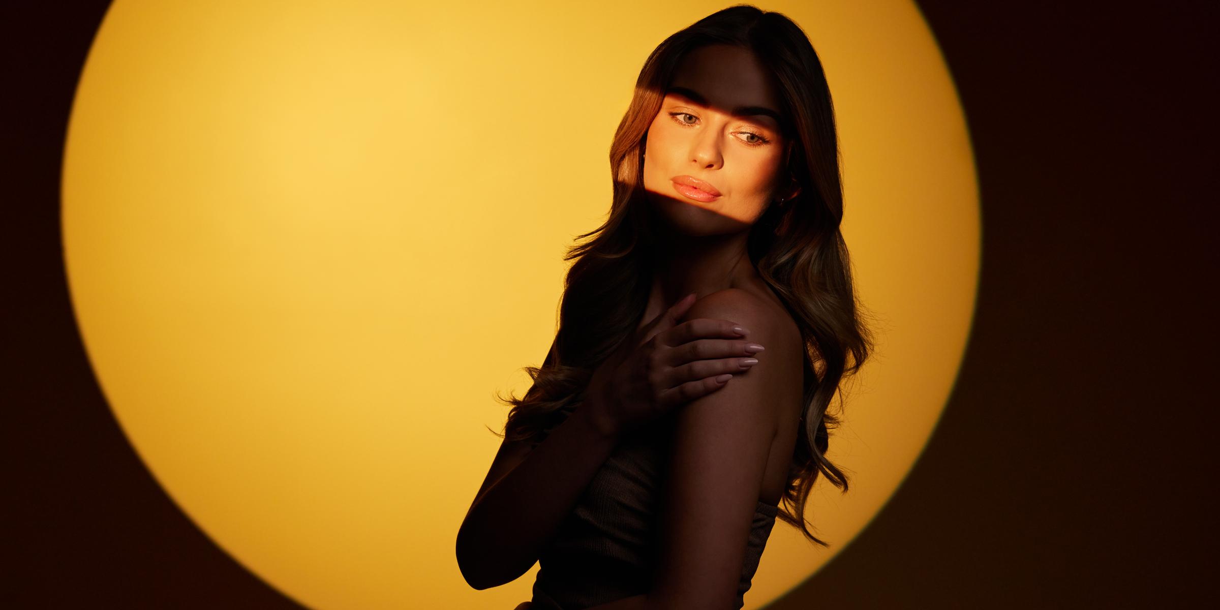 Woman with beautiful skin and LED Face Mask Pro
