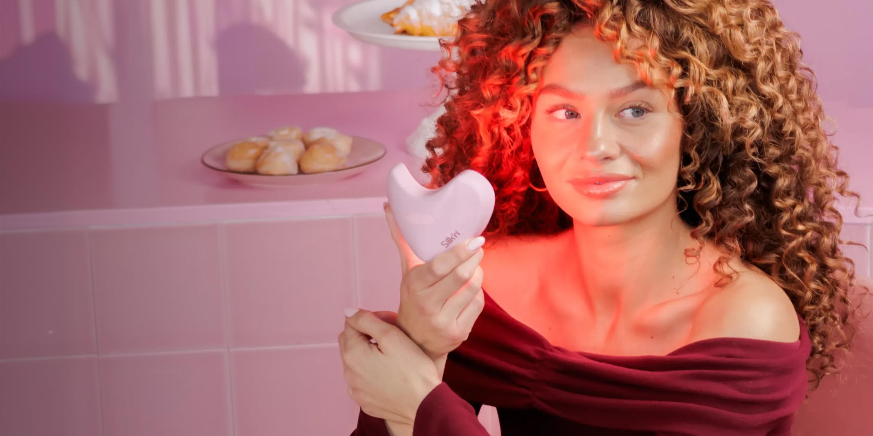 Woman holding the LumiLips Pink - LED Light therapy for your lips