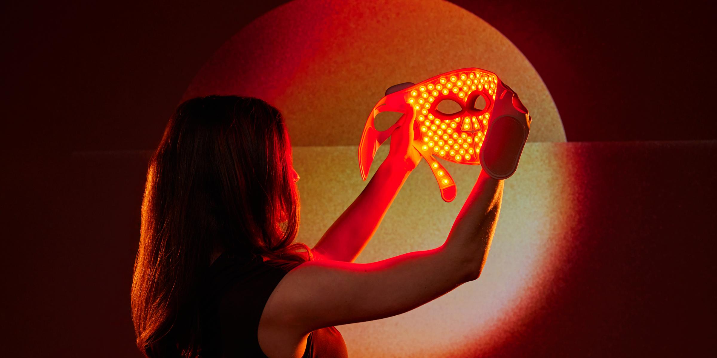 Femme mettant le masque &agrave; lumi&egrave;re rouge visible - LED Face Mask Pro