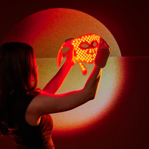 Woman watching the red light mode of her LED Face Mask Pro