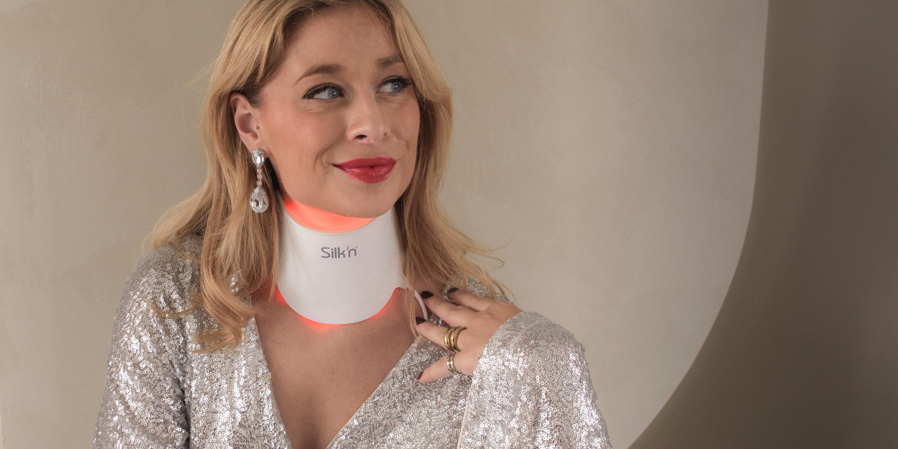 Festive woman wearing the LED Neck Mask