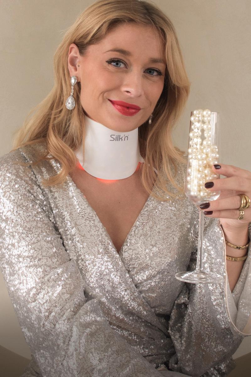 Festive woman wearing the LED Neck Mask