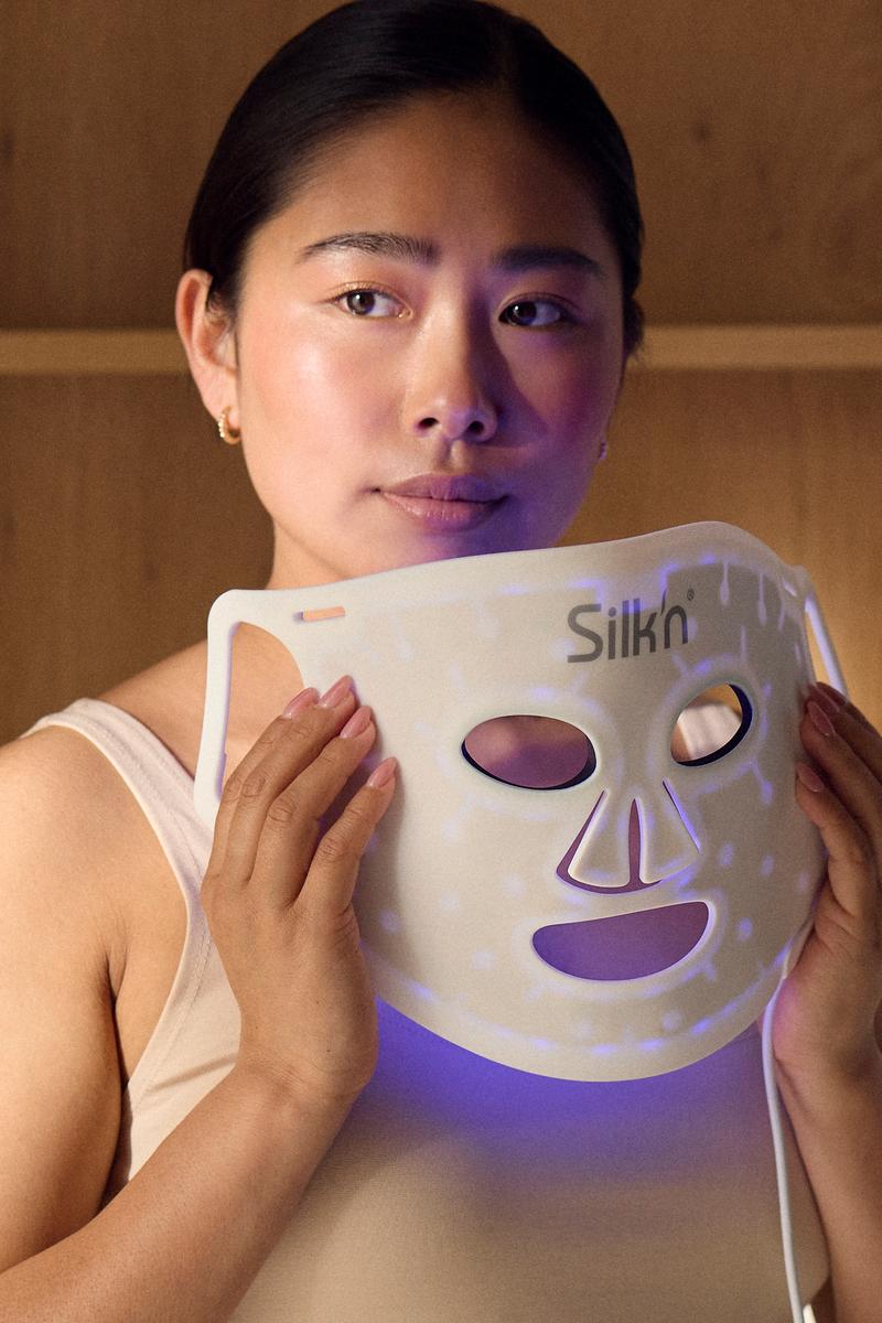 Woman using LED Face Mask 100 with blue light