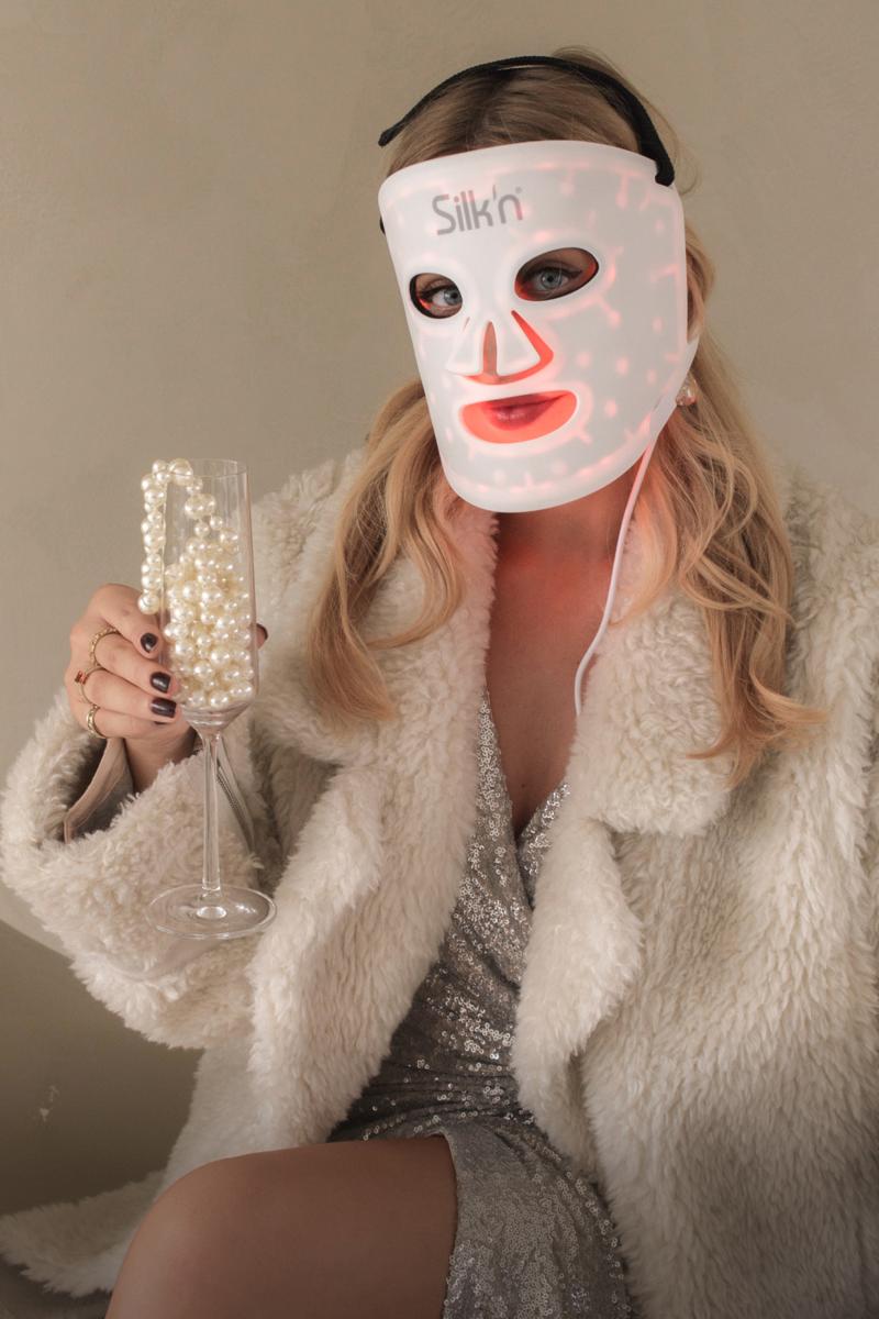 A beautifully dressed woman in a festive mood with the LED mask 100